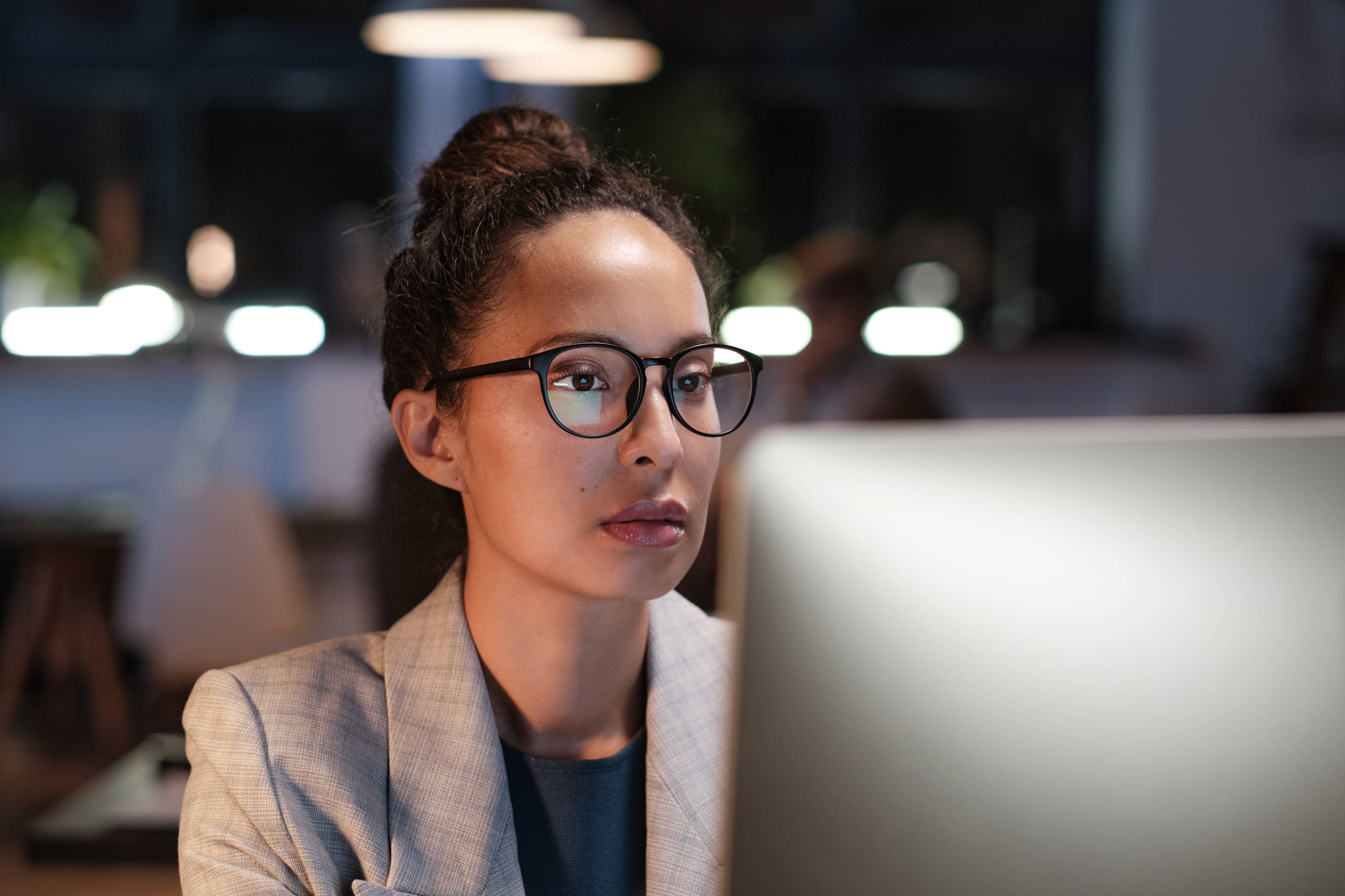 Young girl foreign specialist sits in front of laptop